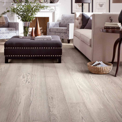 Light-stained engineered hardwood flooring in a modern Ann Arbor living room with neutral decor, a fireplace, and contemporary furniture.